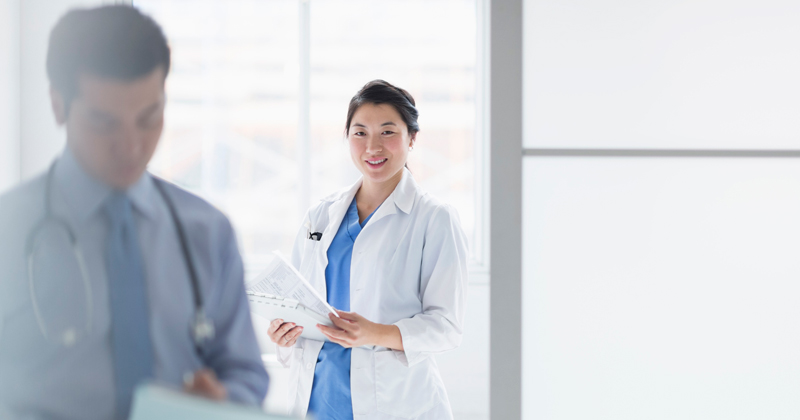 Two female doctors looking at a tablet