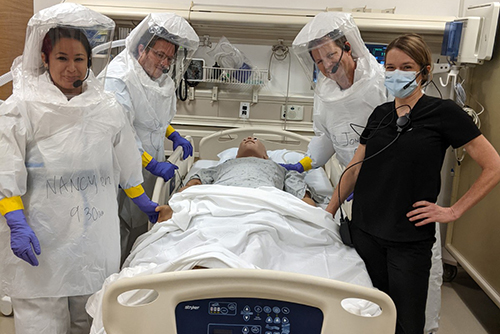 Oren Friedman, MD; Nancy Salinas, RN; Jennifer Cuzzolina, RN; and Jonathan Grein, MD, engage in special pathogens training. (Photo by Ronnie Wong, MPH.).