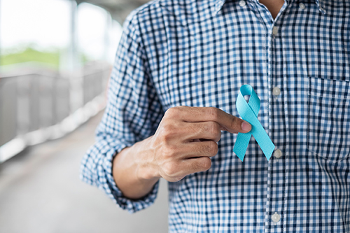 Midsection Of Man Holding Blue Ribbon